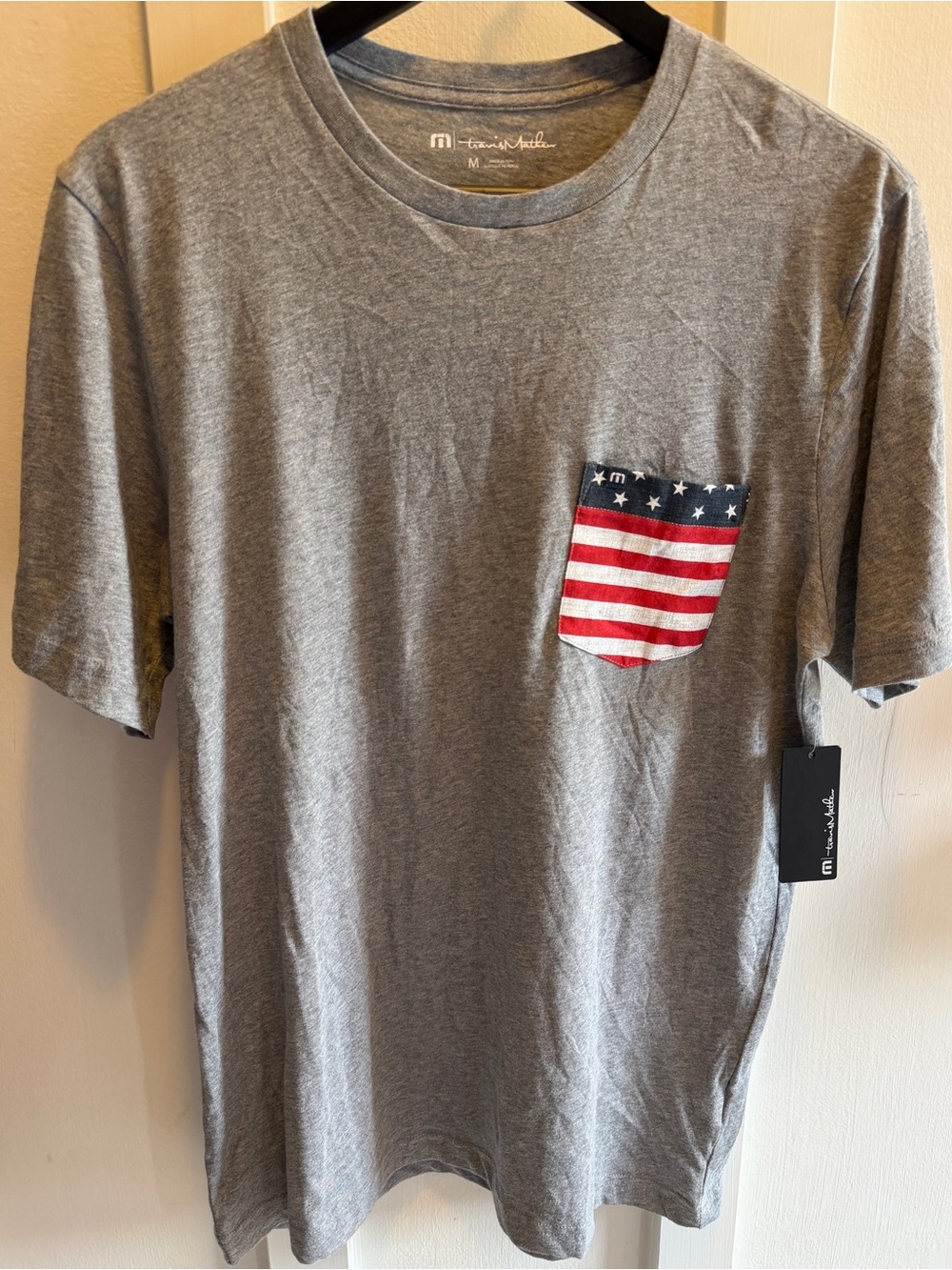 Travis Mathew " Party On" Grey Short Sleeve Tee with American Flag Pocket